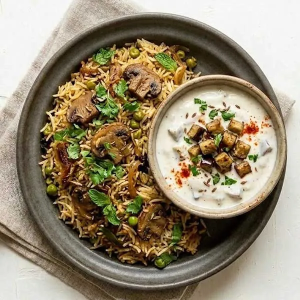 Mushroom & mutter dum biryani with eggplant raita